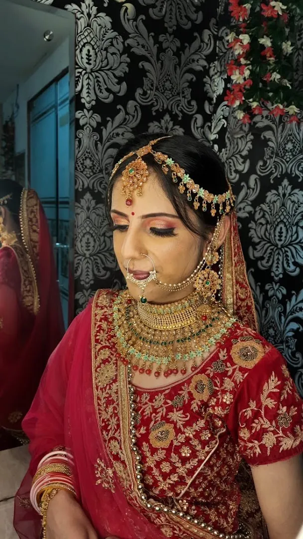 A bride in red and gold with bridal hair and makeup by Shriji Beauty Touch