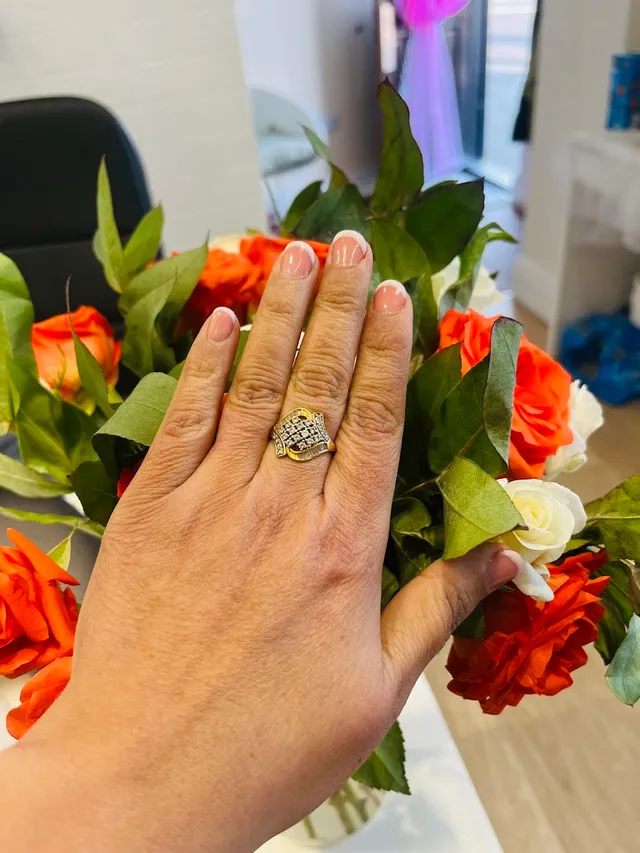 Painted nails resting on fresh roses